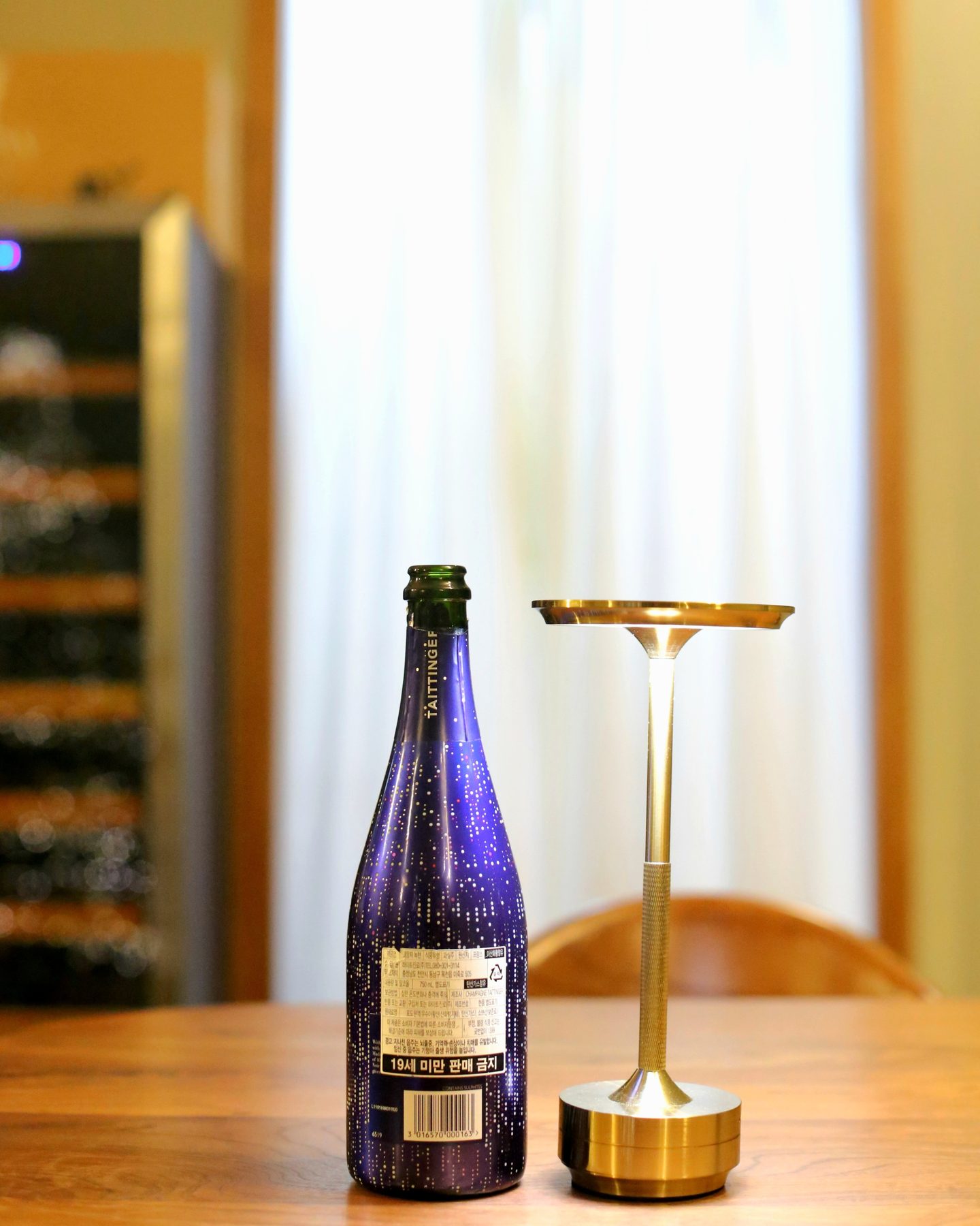 A bottle of Taittinger Nocturne City Lights Sec Champagne.