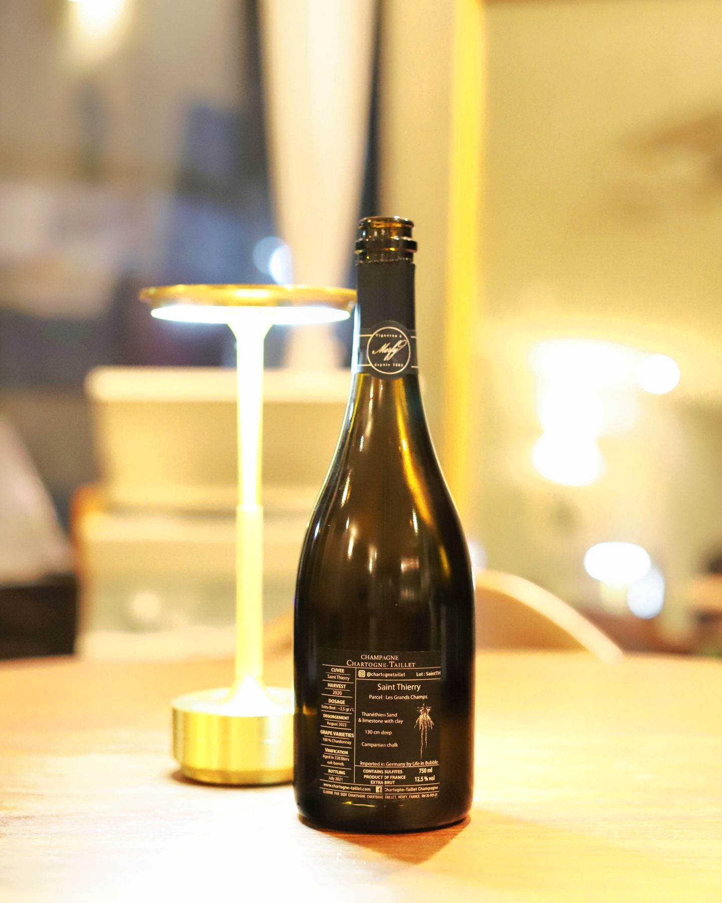A bottle of Chartogne-Taillet Saint Thierry Extra Brut Champagne 2020, seen from another angle.
