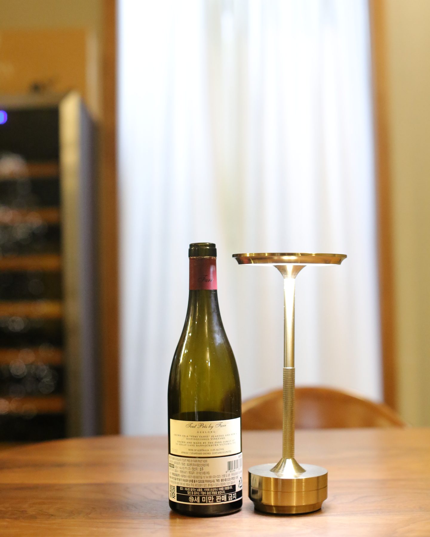 A bottle of By Farr Tout Près Pinot Noir 2018, seen from another angle.