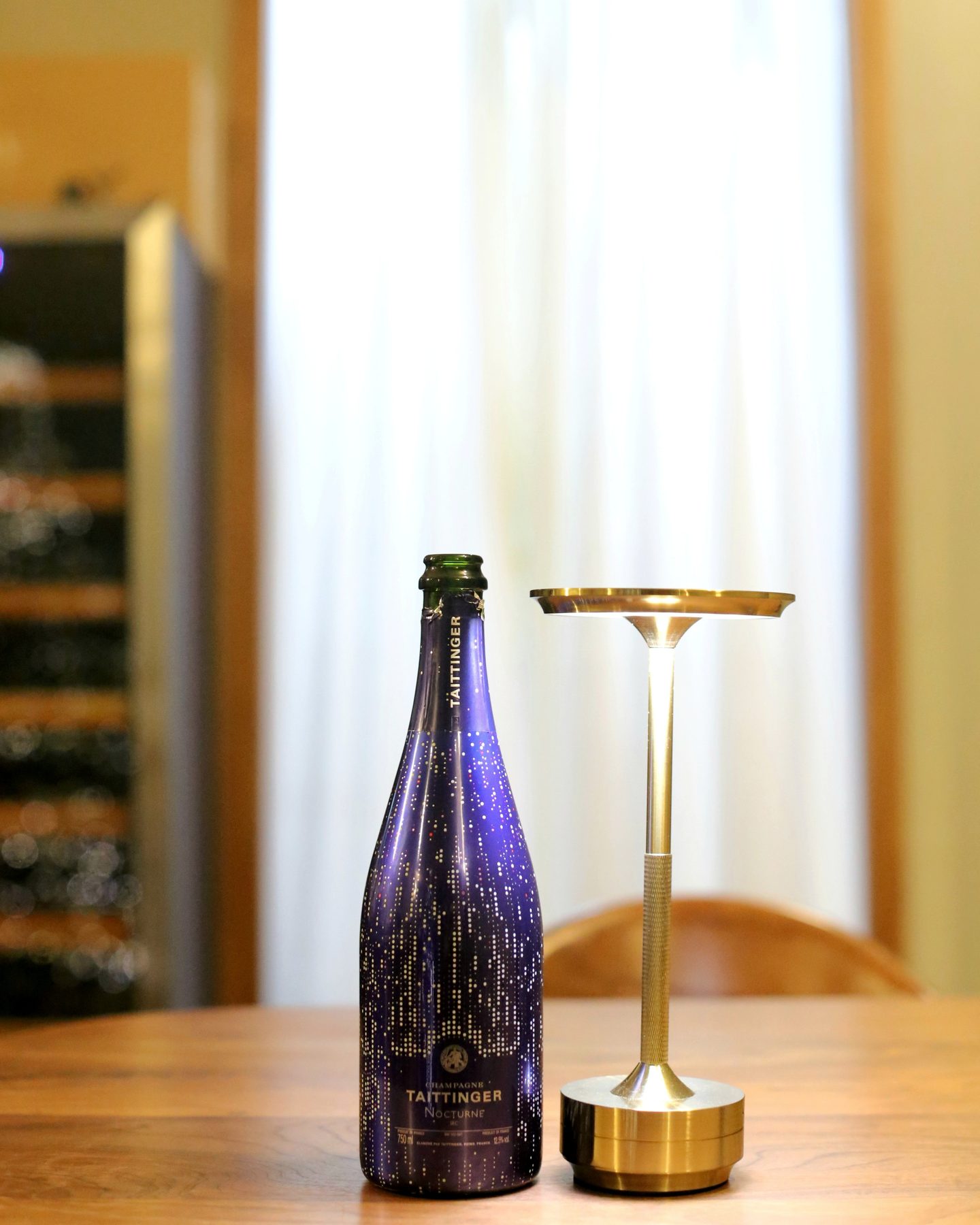 A bottle of Taittinger Nocturne City Lights Sec Champagne.